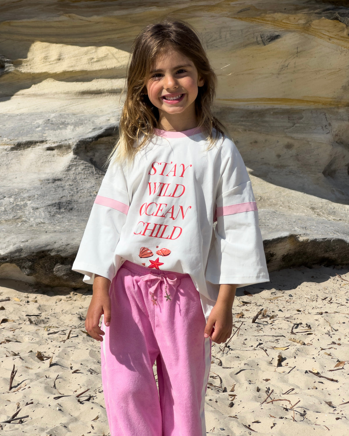 Stay Wild Ocean Child Tee, girls' oversized white graphic tee, front view
